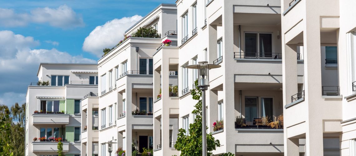 The facade of some white modern apartment buidlings seen in Berlin, Germany